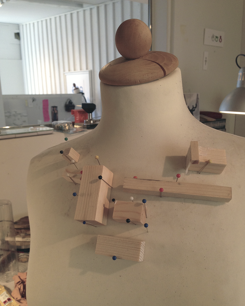 Wooden blocks pinned to a mannequin for wet molding leather.